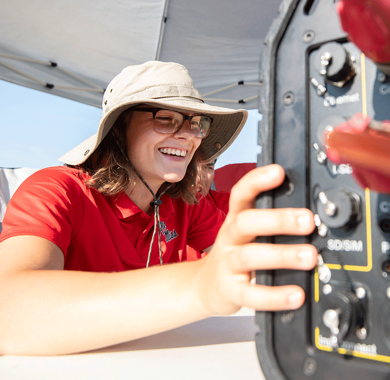 woman conducting research on a boat